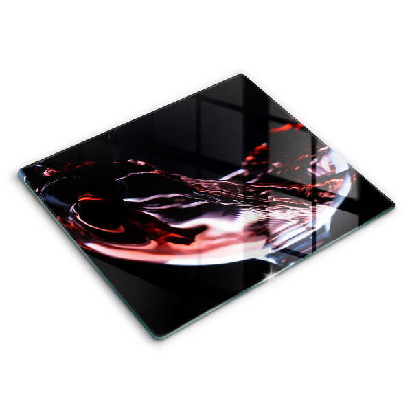 Skärbräda av glas Ett glas rött vin