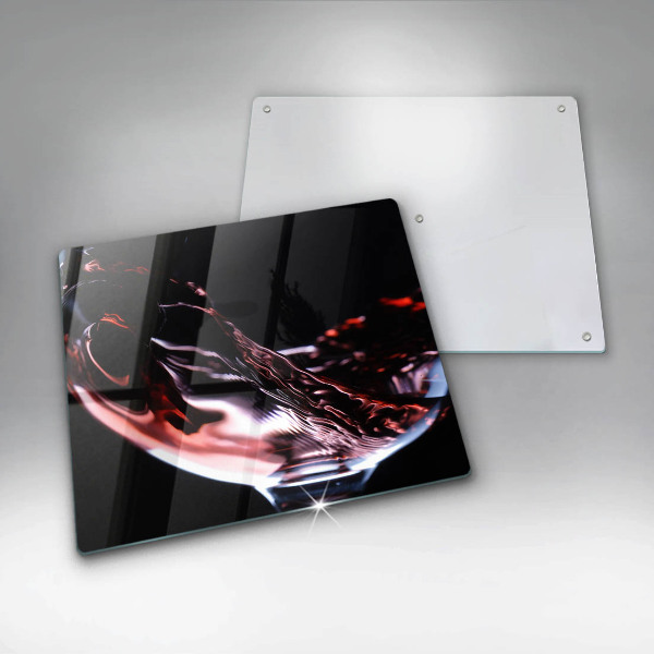 Skärbräda av glas Ett glas rött vin