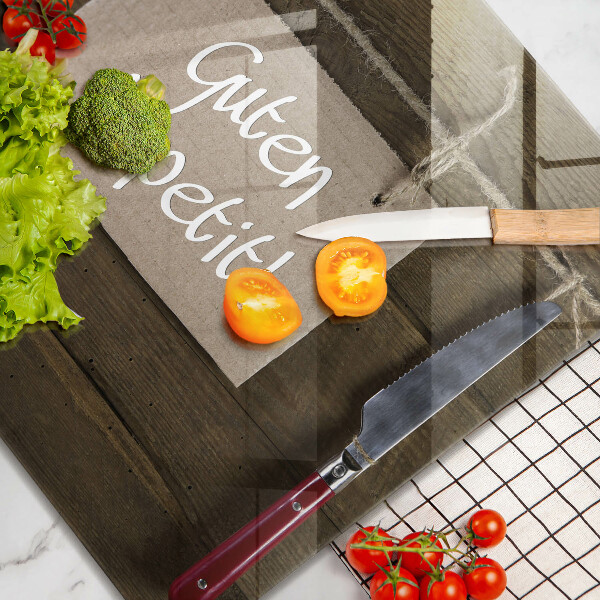 Skärbräda av glas På brädorna står det Guten Apetit