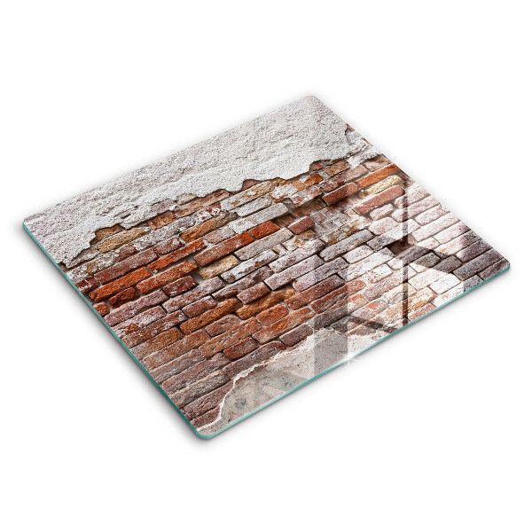 Skärbräda av glas Gammal tegel- och betongvägg