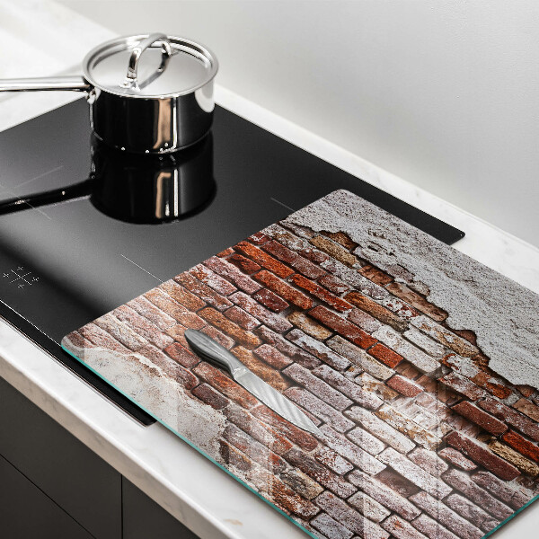 Skärbräda av glas Gammal tegel- och betongvägg