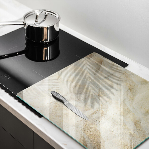 Skärbräda av glas Palmblad och sand