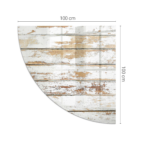 Fjärdedelscirkel glasskiva framför öppen spis Sliten träplanka