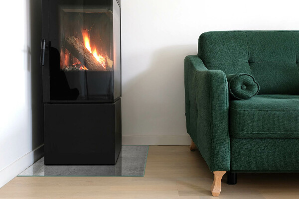 Kvadratisk glasskiva framför öppen spis Textur av rå betong