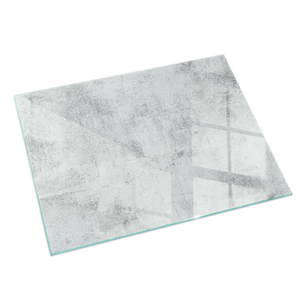 Rektangulär glasskiva framför öppen spis Rå betongstruktur