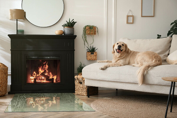 Rektangulär glasskiva under kamin Tropiska blad i bakgrunden